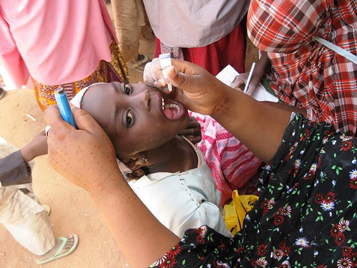 Nigerian girl receiving polio vaccine