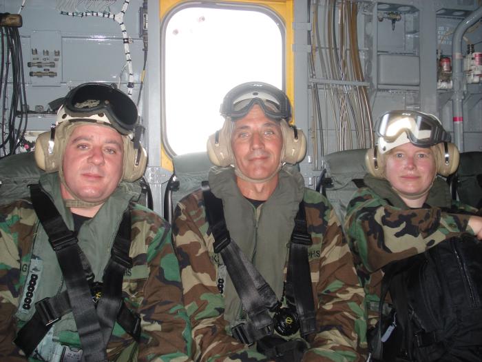 US Public Health Service officers riding a US Navy helicopter