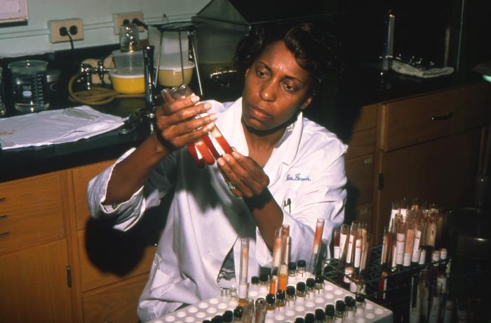 Laboratorian conducting biochemical tests on blood specimens