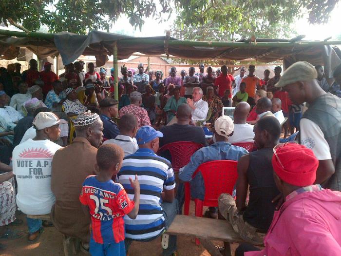 Public Health Advisor, Joe Posid, MPH, meeting with a gathering of villagers